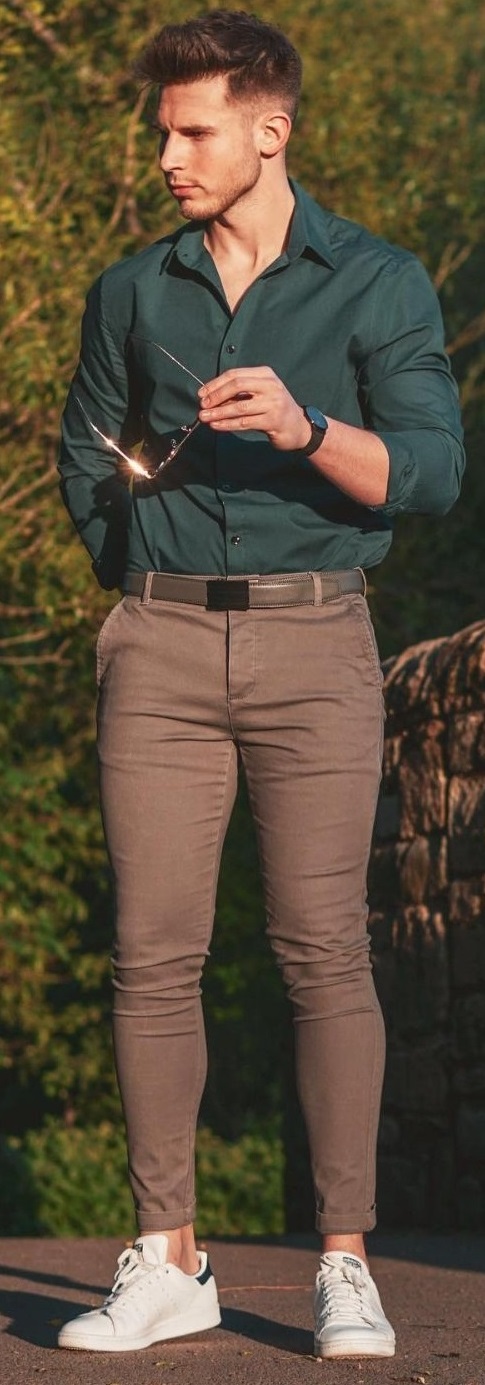 Green shirt with brown trousers and a belt, accessorized with shades_ Green shirt with brown trousers and a belt, accessorized with shades_