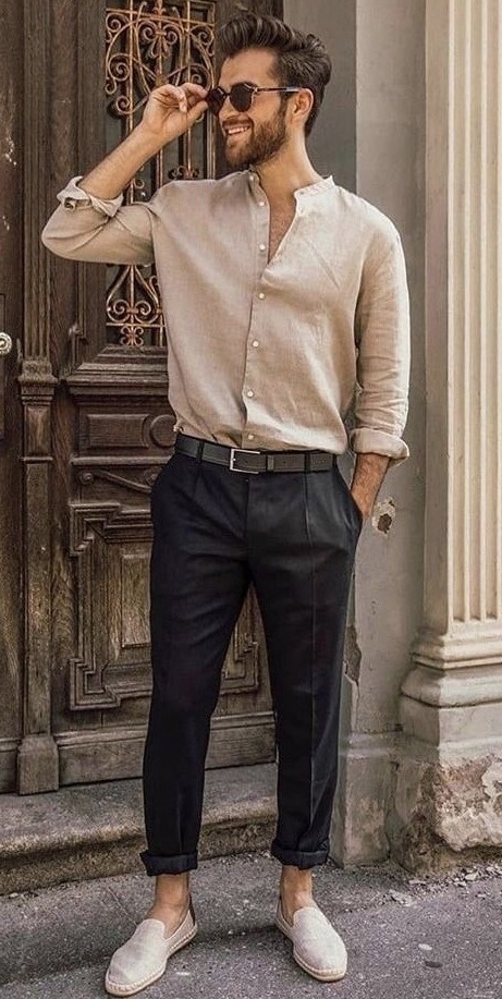 beige shirt with black trousers wearing a leather boot accessorized with shades_ beige shirt with black trousers wearing a leather boot accessorized with shades_