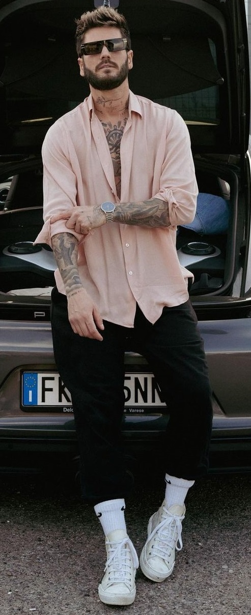beige shirt with opened buttons and black joggers and white sneakers with shades beige shirt with opened buttons and black joggers and white sneakers with shades