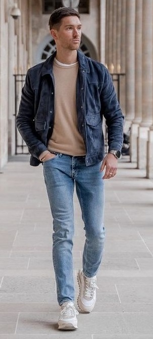 beige t-shirt with blue denims and dark blue jacket wearing white sneakers_ beige t-shirt with blue denims and dark blue jacket wearing white sneakers_