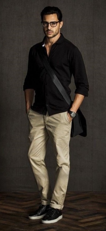 black shirt with cream chinos accessorized with a watch and a bag and black shoes_ black shirt with cream chinos accessorized with a watch and a bag and black shoes_