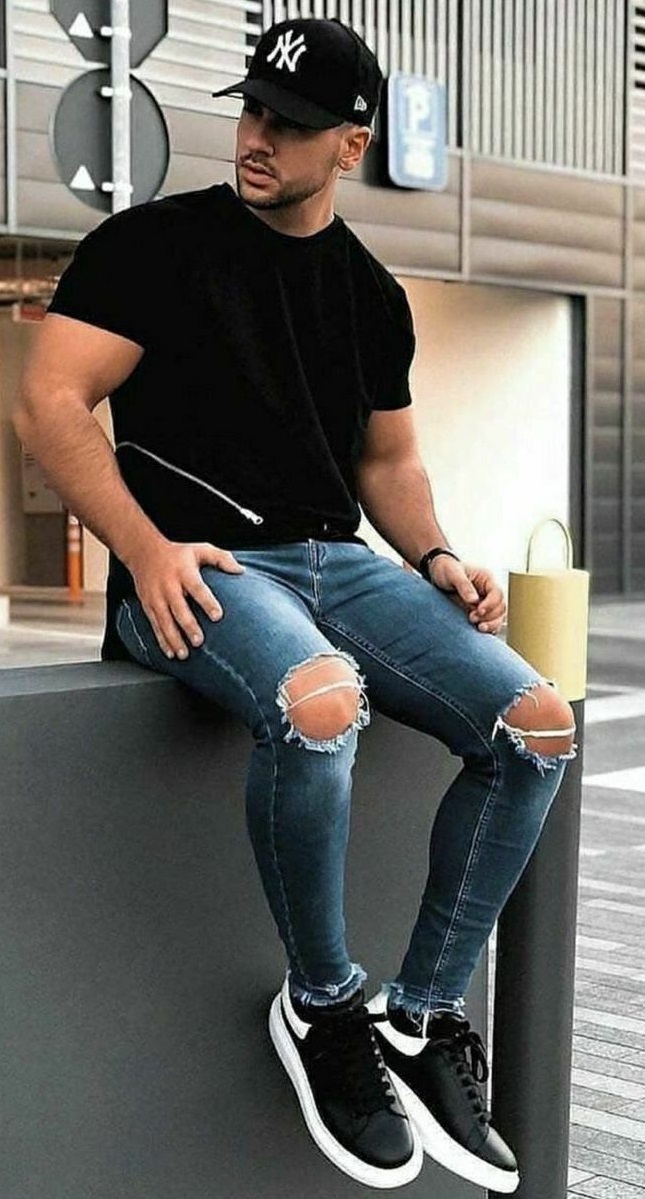 black t-shirt with ripped denims and a cap wearing black shoes_ black t-shirt with ripped denims and a cap wearing black shoes_