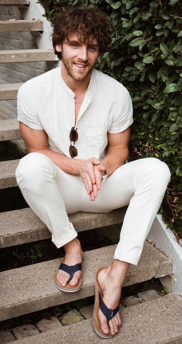 off white shirt with off white chinos and shades, wearing slippers_ off white shirt with off white chinos and shades, wearing slippers_