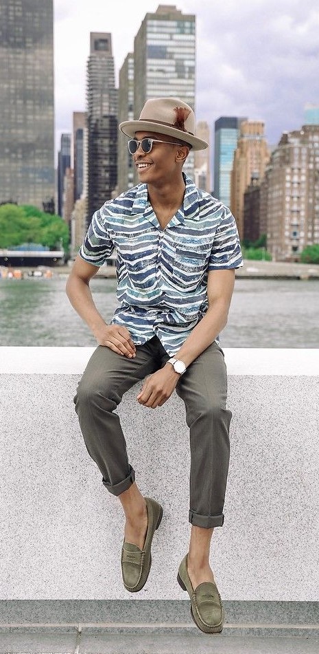 printed shirt with grey trousers accessorized with shades, hat and a watch_ printed shirt with grey trousers accessorized with shades, hat and a watch_