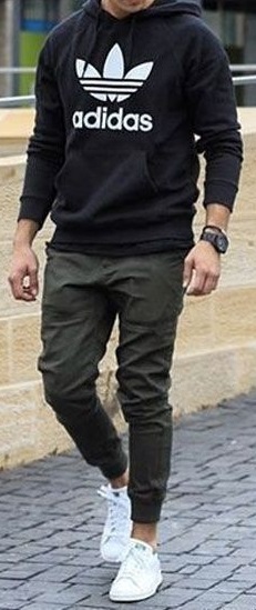 green men's joggers with black hoodie and white sneakers accessorized with a watch green men's joggers with black hoodie and white sneakers accessorized with a watch