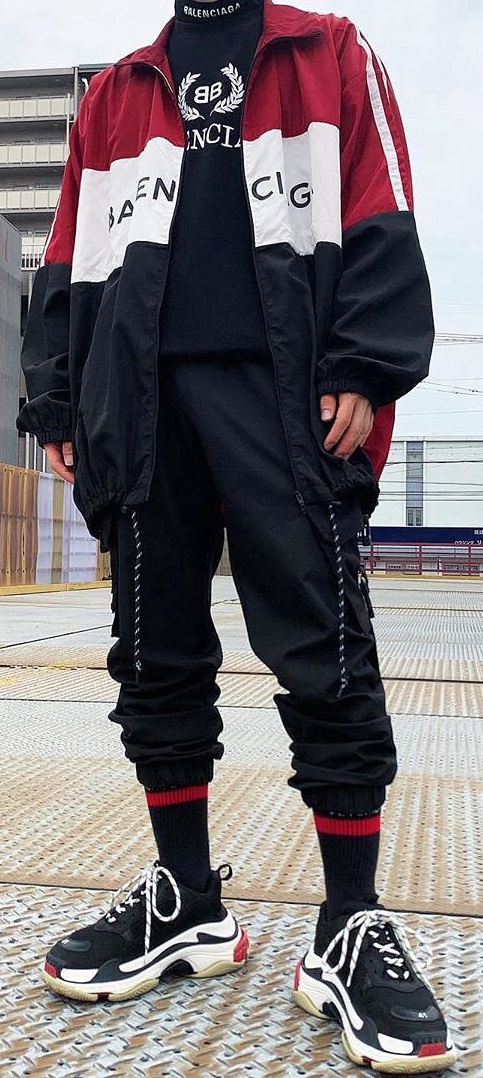 Balenciaga Triple S Sneakers with socks. He is wearing a tshirt with joggers being one of the must-have products to own Balenciaga Triple S Sneakers with socks. He is wearing a tshirt with joggers being one of the must-have products to own