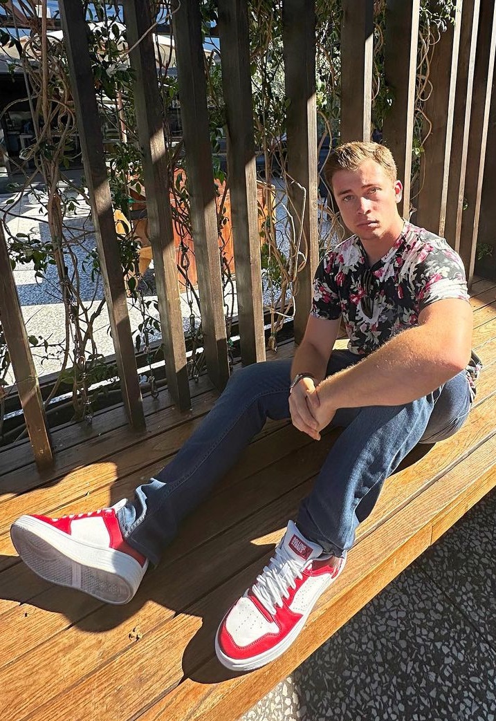 a floral shirt with denims and a sneaker brand - Skechers a floral shirt with denims and a sneaker brand - Skechers