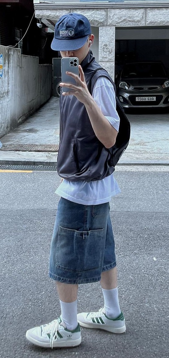 a jacket with a tshirt and and shorts, accessorized with a sneaker brand Adidas and a cap a jacket with a tshirt and and shorts, accessorized with a sneaker brand Adidas and a cap