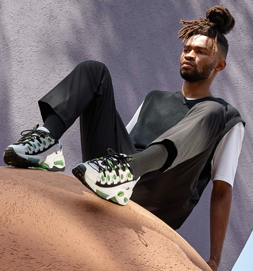 black vested top with a white undershirt and a black denim and a sneaker brand - Puma black vested top with a white undershirt and a black denim and a sneaker brand - Puma
