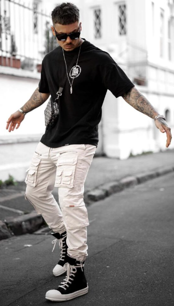 classic cargo pants of white color with black tshirt, accessorized with shades, locket and watch with shoes classic cargo pants of white color with black tshirt, accessorized with shades, locket and watch with shoes