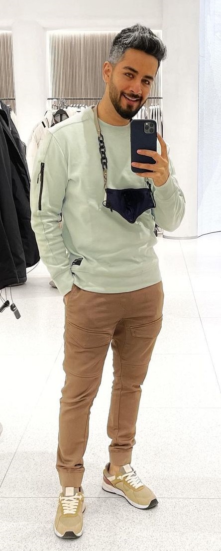 green full-sleeved tshirt with brown cargo pant, accessorized with a mask and shoes green full-sleeved tshirt with brown cargo pant, accessorized with a mask and shoes