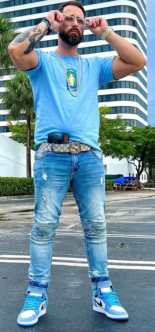 Gucci belt being a must-have product to buy with denims and blue tshirt, accessorized with glasses. neck-chain and a bracelet Gucci belt being a must-have product to buy with denims and blue tshirt, accessorized with glasses. neck-chain and a bracelet